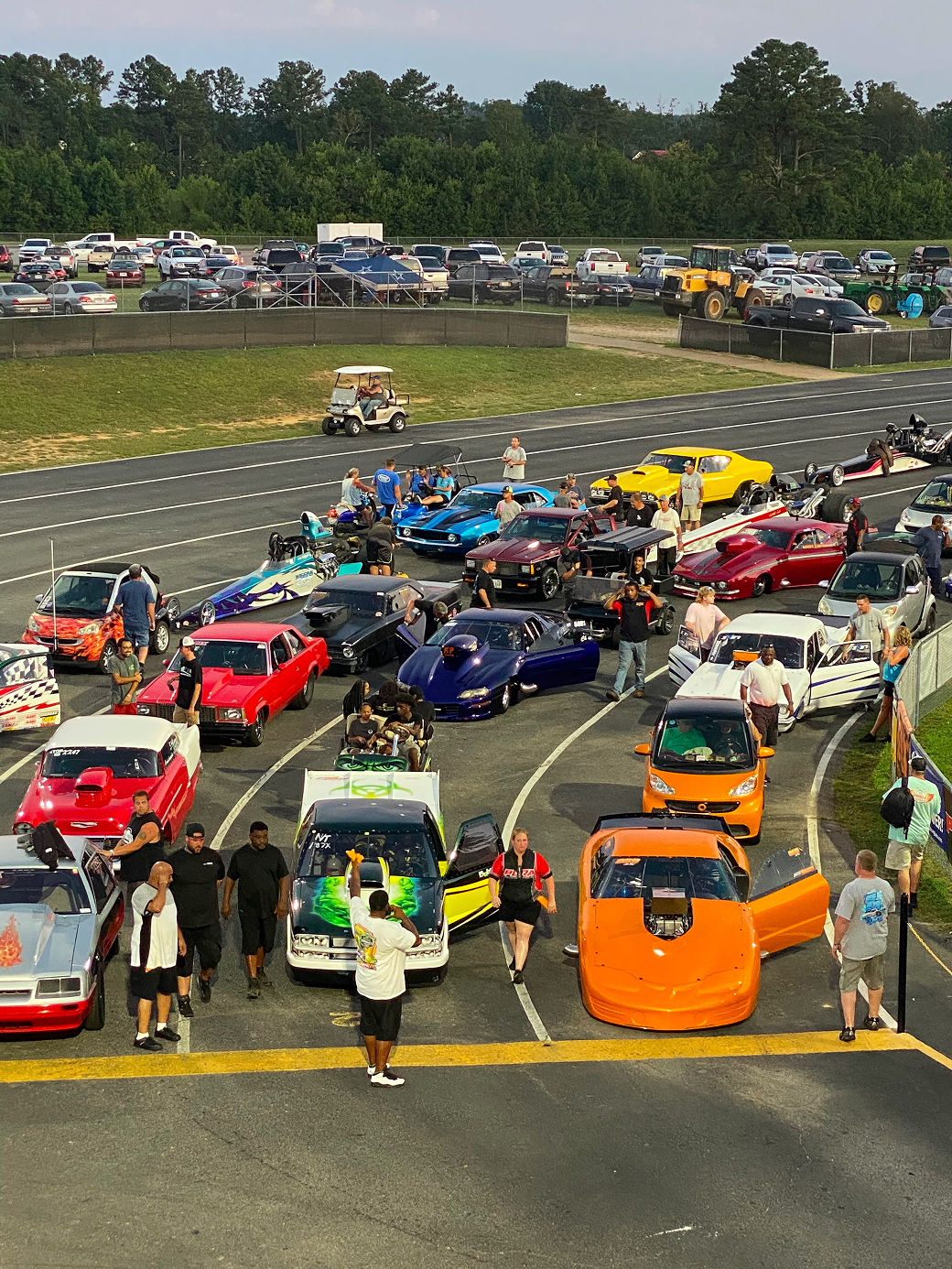 People admire colorful cars at exhibition