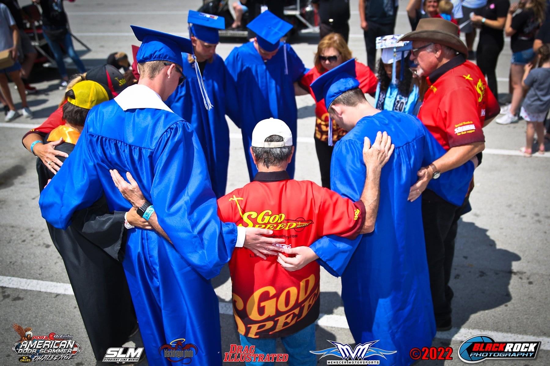 Group prayer before graduation ceremony